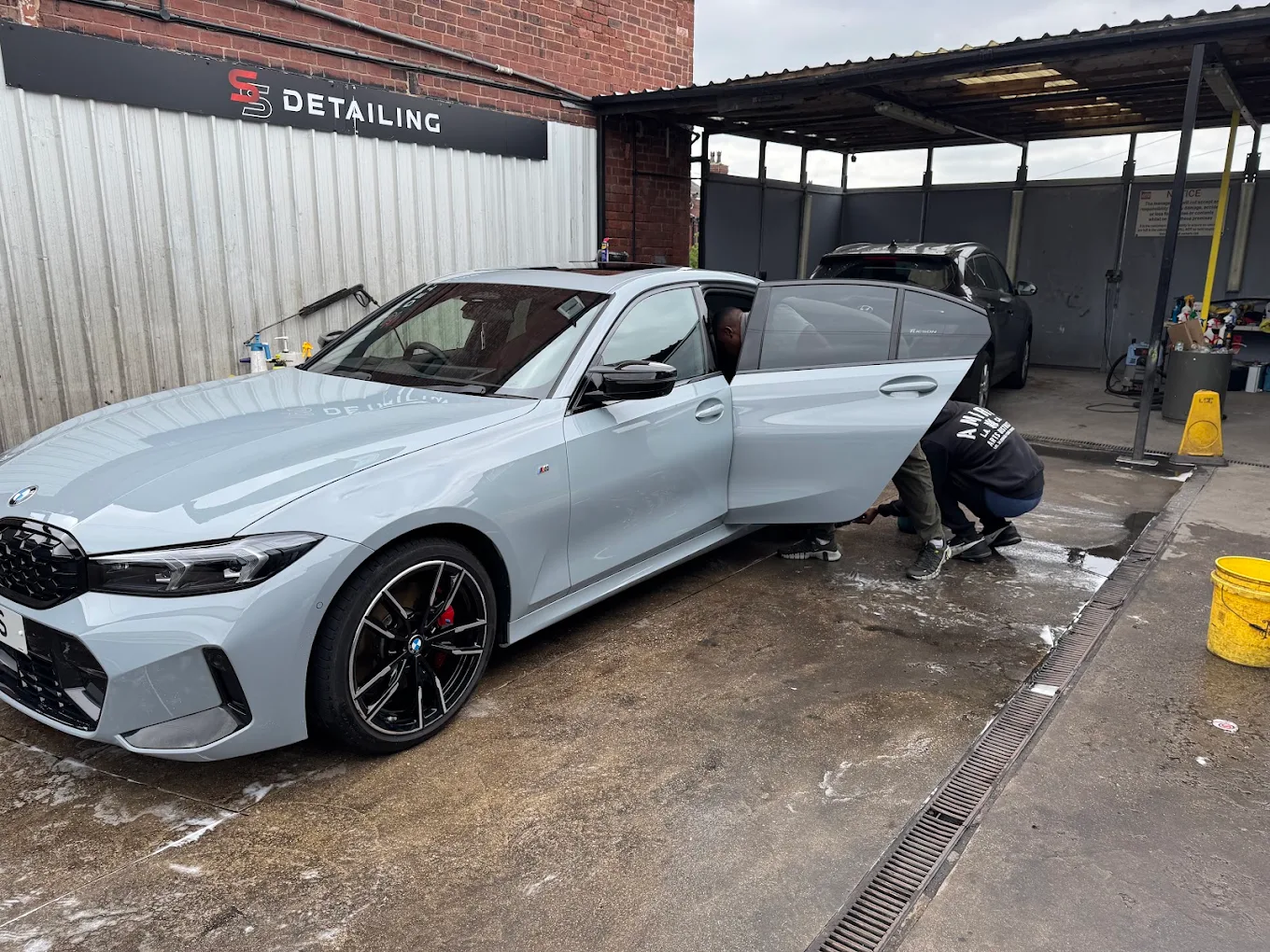 SS Detailing team working on a silver BMW at the Leeds unit